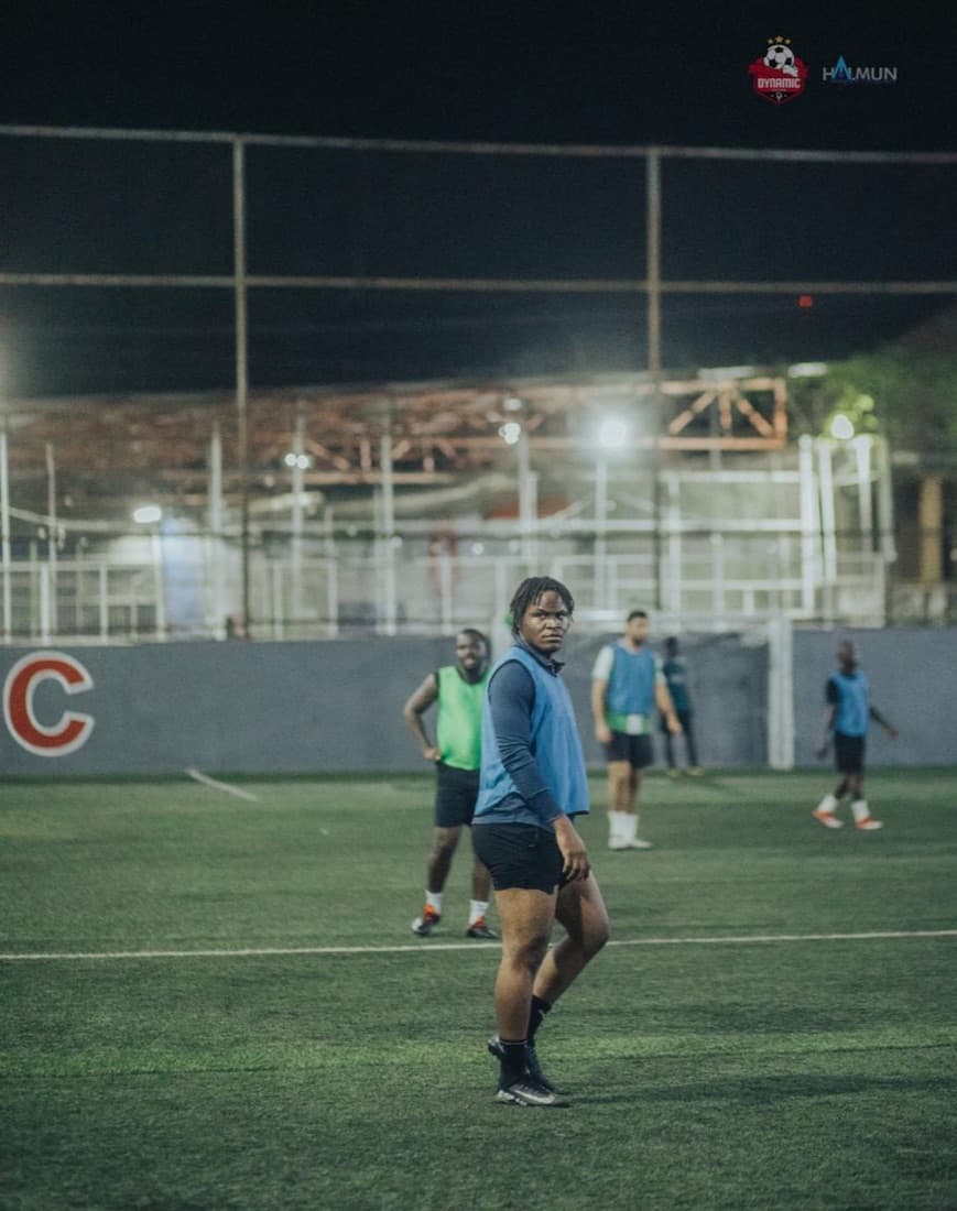 Looking back over the shoulder mid-game in a blue bib.