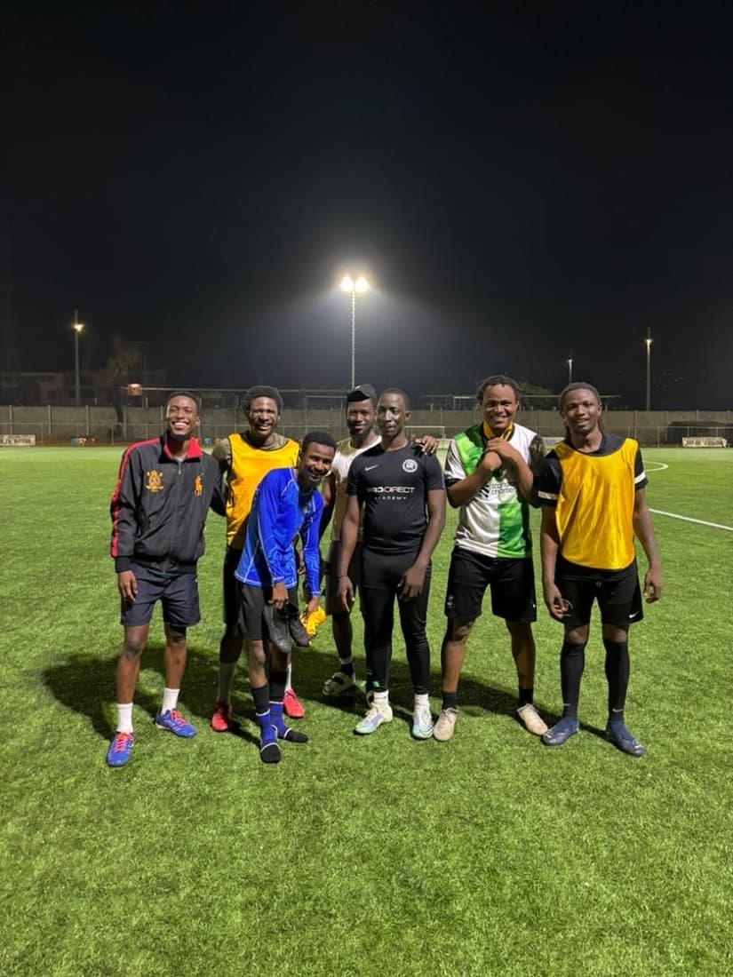 Seven players shoulder to shoulder, grinning under the lights.