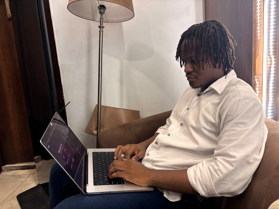 Working from an armchair at a restaurant, laptop on the knees.